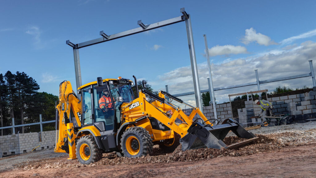 JCB 3CX Compact Excavator digging up the ground as part of our construction vehicles fleet