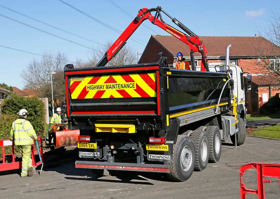 Picture of the thompson 32t tipper grab working on the roads collecting rubble